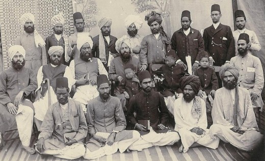 Mizra Ghulam Ahmad is in the center with a child on his lap.