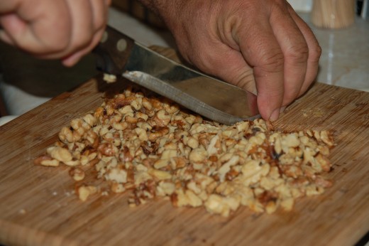  Coarsely chop to about 1/4 original size all walnuts to be used in this dish.