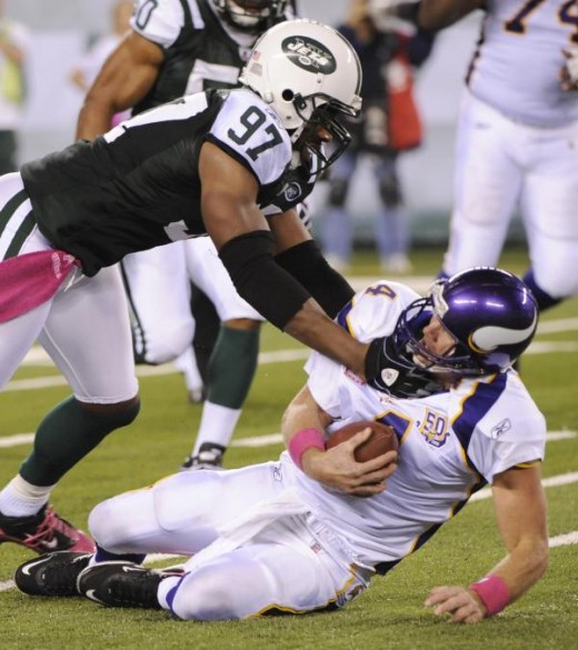 Minnesota Vikings' Brett Favre is sacked by New York Jets' Calvin Pace during the second quarter of an NFL football game Monday, Oct. 11, 2010, in East Rutherford, N.J. A facemask penalty was called on Pace on the play. (AP Photo/Bill Kostrou
