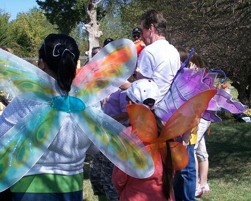 'Butterflies' gather to hear the names of lucky children announced who get to help release a real butterfly on its southern journey.