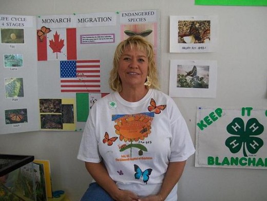 Nora, of Blanchard 4-H Club demonstrates her student's handiwork and has lots of educational brochures also.