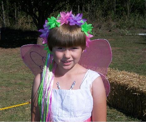 This cute butterfly costumed child was given a special colorful headdress by a relative.  She was quiet, sweet, and enjoying the festivities.