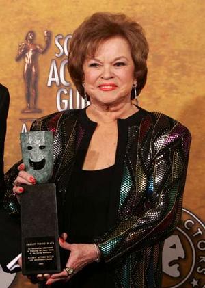 A mature Shirley Temple accepts an award from the Sceen Actors Guild
