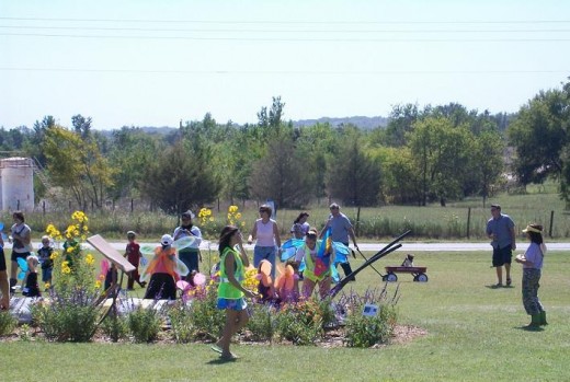 The Butterfly Parade ended at the giant caterpillar for picture-posing.  Annie Hart is at far right, reveling and relaxing in the joy of another Festival so enjoyed by others!