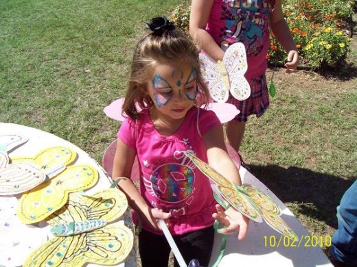 Picking out a butterfly to wear in the Childrens Butterfly Parade.