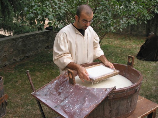 A man making paper, using ancient methods.