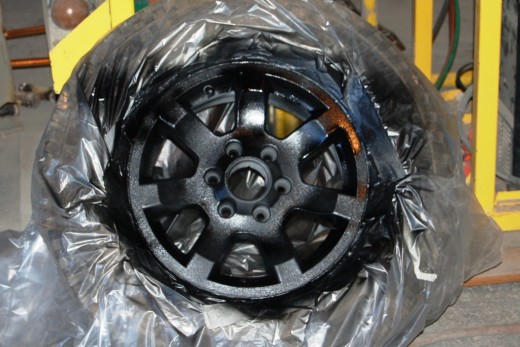 Had to work late tonight, so I experimented with bedlining the rim of my spare tire.  It turned out alright.