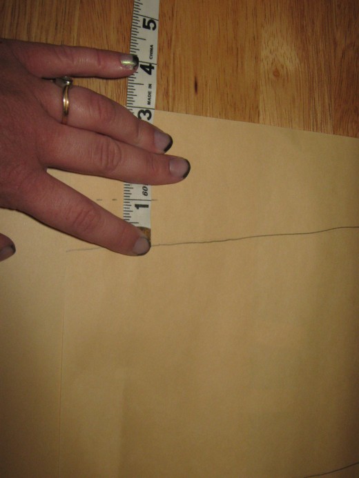 After tracing your pattern use your tape measure to measure one inch all the way around your pattern (except for the top where it will be two inches) marking it using your pencil.