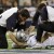 Dallas Cowboys quarterback Tony Romo is tended to during the first half of against the New York Giants in an NFL football game Monday, Oct. 25, 2010, in Arlington, Texas. Romo was drilled into the turf on his left shoulder, forcing him to the locker 