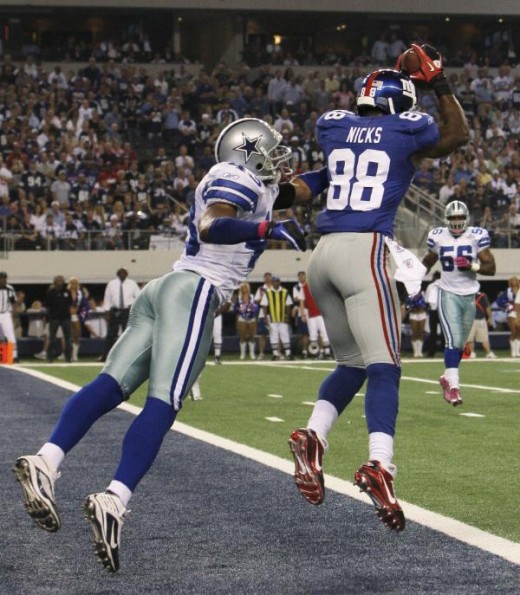New York Giants wide receiver Hakeem Nicks, right, makes a touchdown reception as Dallas Cowboys safety Gerald Sensabaugh (43) defends during the first half of an NFL football game Monday, Oct. 25, 2010, in Arlington, Texas. (AP Photo/LM Otero)
