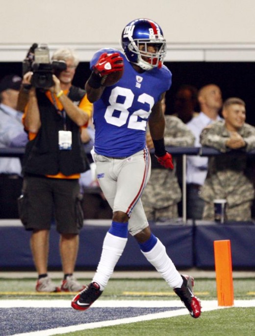 New York Giants wide receiver Mario Manningham scores a touchdown against the Dallas Cowboys during the second half an NFL football game Monday, Oct. 25, 2010, in Arlington, Texas. (AP Photo/Mike Fuentes)