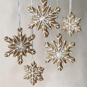 gingerbread snow flake cut outs. Royal icing piped on with cake decorating tools to make a design. Don't forget to make a hole at the top............... before you bake the cookie.