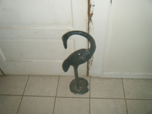 Here is the 10 pound brass bird against the door it is supposed to keep closed. However this bird quite often is moved away from the door. 