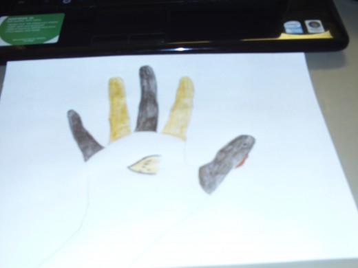 Notice how the main part of the hand tracing is left blank since the main part of my turkey's body has white feathers, but you can make your turkey any color you like.  I just wanted to color in the "feathers" and the head on my turkey.