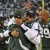 New York Jets quarterback Mark Sanchez (6) hugs offensive coordinator Brian Schottenheimer after throwing a touchdown-pass as teammates Santonio Holmes (10) and Jason Taylor (99) look on during the fourth quarter of an NFL football game against the H