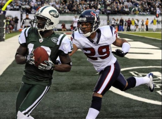 New York Jets wide receiver Santonio Holmes (10) catches the game-winning touchdown-pass as Houston Texans cornerback Glover Quin (29) pursues during the fourth quarter of an NFL football game at New Meadowlands Stadium, Sunday, Nov. 21, 2010, in Eas
