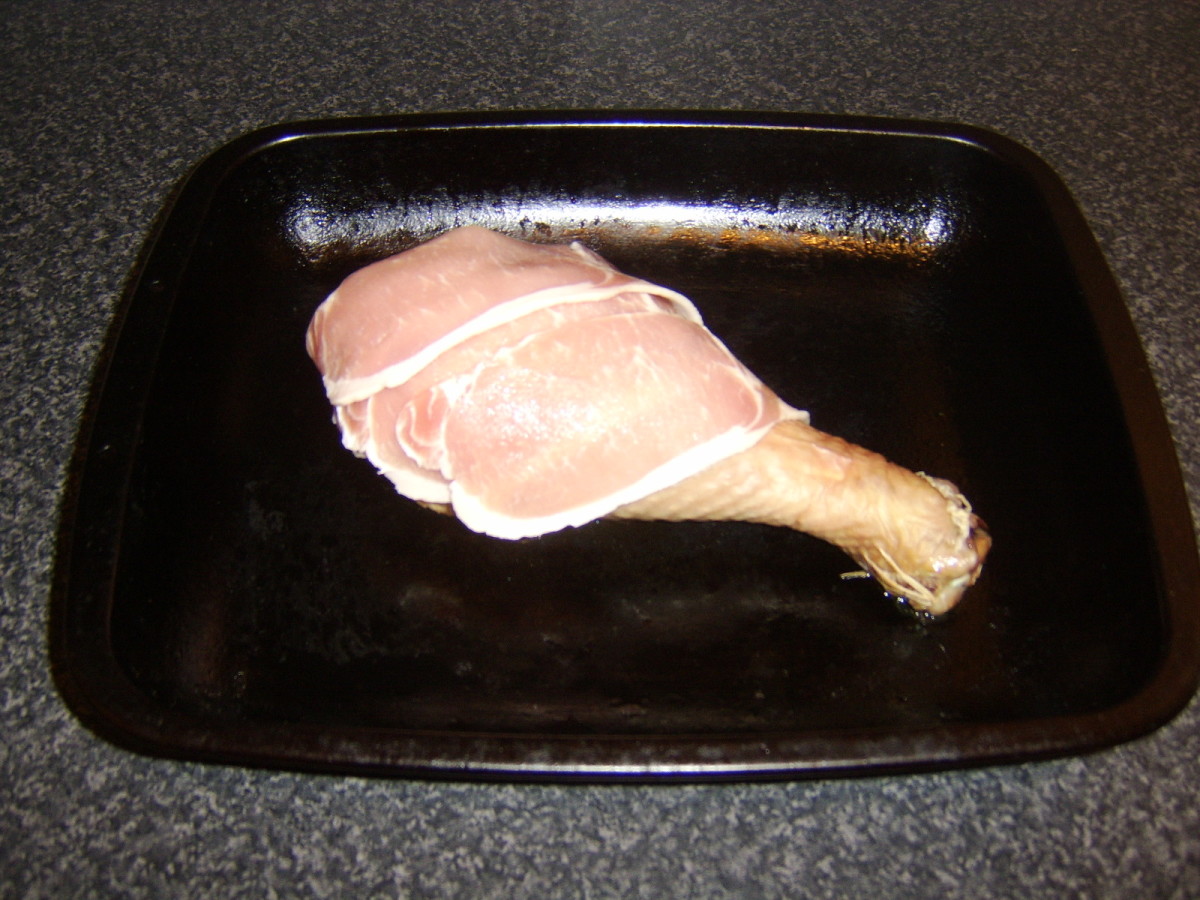 Partially Cooked Turkey Drumstick is Draped with Bacon