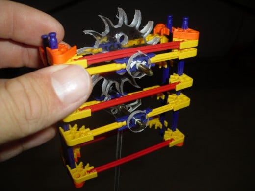 K'Nex construction blocks, used instead of Legos, along with some custom designed parts made of poly carbonate. 