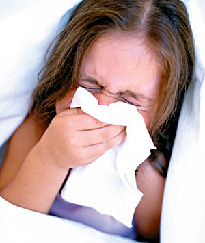 Sneezing into a tissue. Remember to throw away the tissue immediately and  wash your  hands.