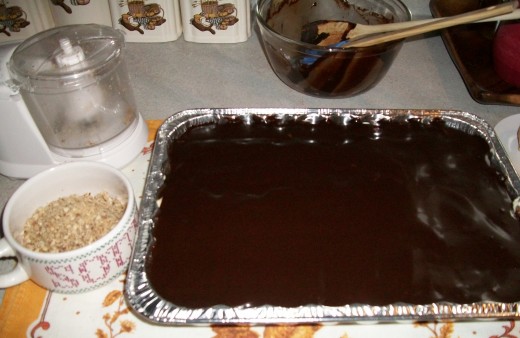 While the frosting is warm, spread it over the upper layer of the cake.