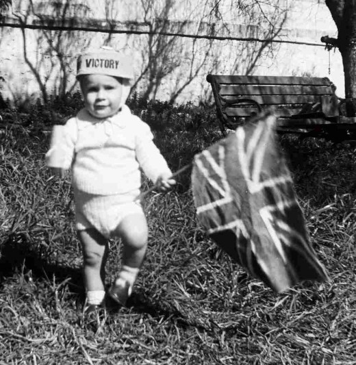 Me, evidently on VE Day, 1945 at the back of Queenie's house