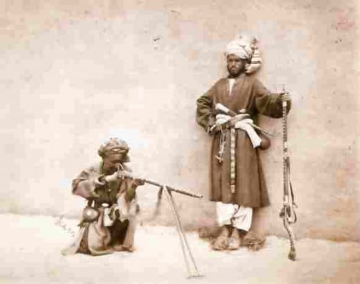 Frontier tribesmen demonstrate the 'jezail' to an early photographer