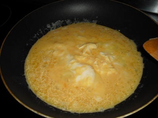 Egg starting to cook - at this point start pressing the edges into the middle with your spatula
