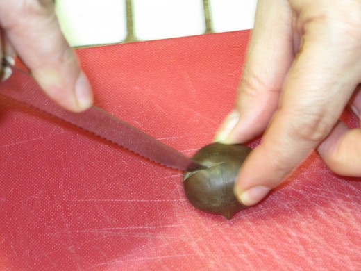 Step 3: Carefully make a slice along the round side of the chestnut.