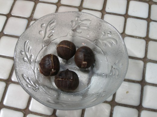 When done, the shell will start to pull away from the nut.  Peel off the shell with your fingers and eat while still warm