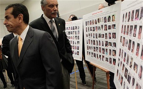 Los Angeles Mayor  Villaragoisa and Former LAPD Chief and now Los Angeles Council Member Parks look at the Grim Sleeper Photographs.