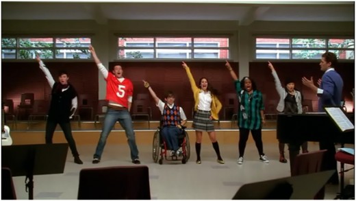New Directions singing "Le Freak" by Chic with little enthusiasm