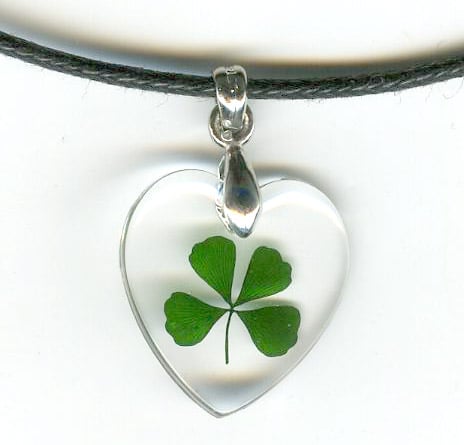 This beautiful Celtic necklace contains a genuine four leaf clover frozen in clear acrylic polyresin suspended on a black cord necklace. Pendant is about the size of a dime.
