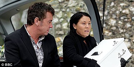 Kat clutches the tiny coffin of who she believes to be her son Tommy.