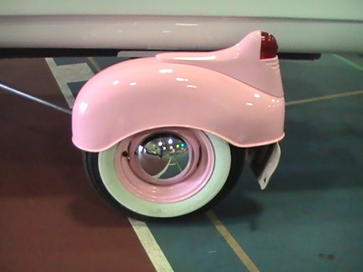 pink and white boat trailer wheel
