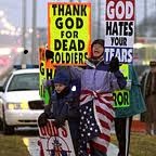 Members From the Cult-Like Westboro Baptist Church Picket During Their Protest of a Military Funeral Carrying Signs That Read "Thank God For Dead Soldiers"