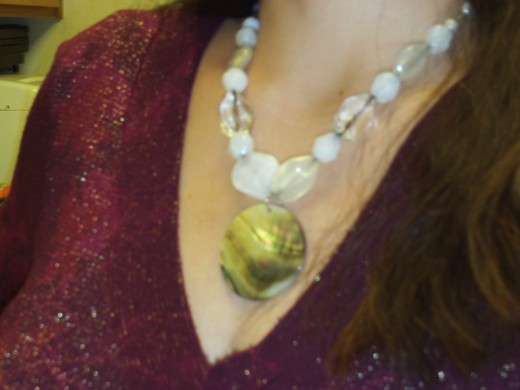 Here is the necklace that I made with the mother of pearl shell pendant.  I used white and clear acrylic beads to match the silver and white tones of the shell pendant.