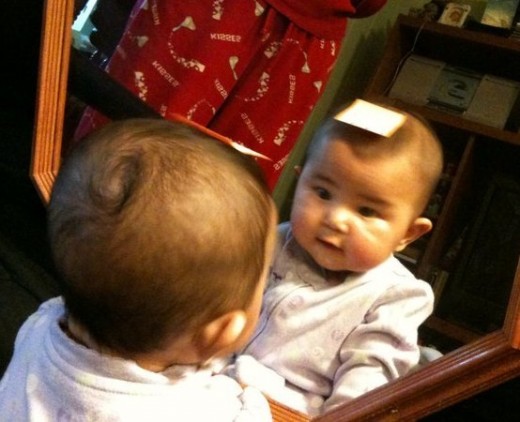 She is unaware that she is looking at herself.