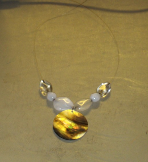 Add one large clear bead to each side of the necklace.