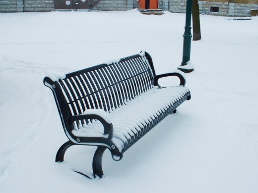 Snow-covered park bench