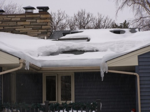 Ice dams on the edges with the heatloss are very visible.