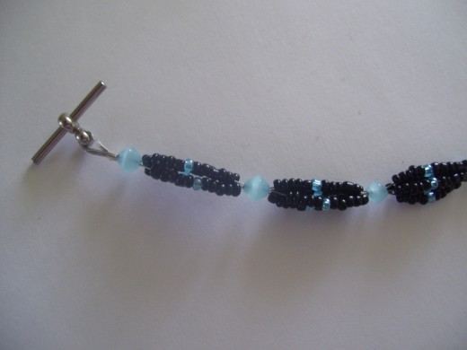 This is four strands that are then woven together using a single bead placed about every inch. 