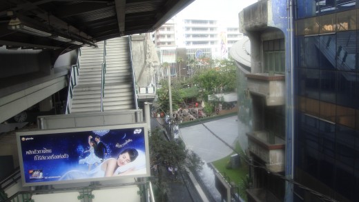 View of cafe from Skytrain exit.  The coffee shop is in the tree area in front of the tall buildings in the picture.
