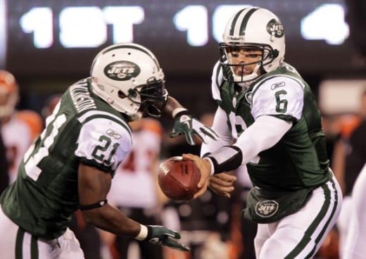 New York Jets Mark Sanchez hands the ball off to LaDainian Tomlinson