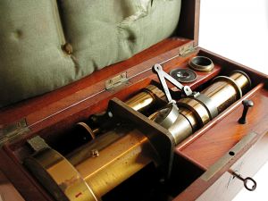 Brass microscope in case, much like one found in various Holmes Museums.
