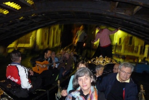 Our gondola ride with music in the gondola beside us as we pass under a bridge.