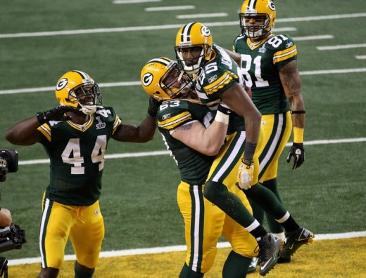 Greg Jennings celebrates with Scott Wells & James Starks after catching a 21 yard touchdown against the Pittsburgh Steelers during Super Bowl XLV at Cowboys Stadium on February 6, 2011 in Arlington, Texas. (Photo by 