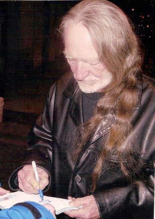 Willie Nelson signing autographs at Westbury Music Fair, Long Island, New York