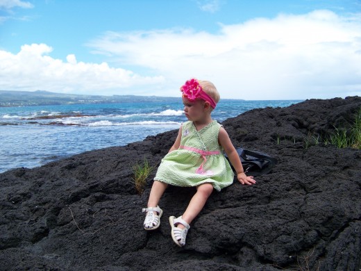 Several of the beaches on the Big Island are lined with lava rock instead of sand.  My baby Aleana enjoyed it, she felt safer from the water. She was the only one of my four kids we got to bring. I am definitely wanting all my children to next time.