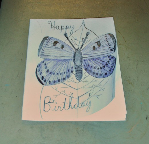 Here I colored in the midsection of the butterfly with a black colored pencil.