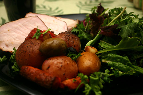 grilled pork roast with roasted vegetables and salad